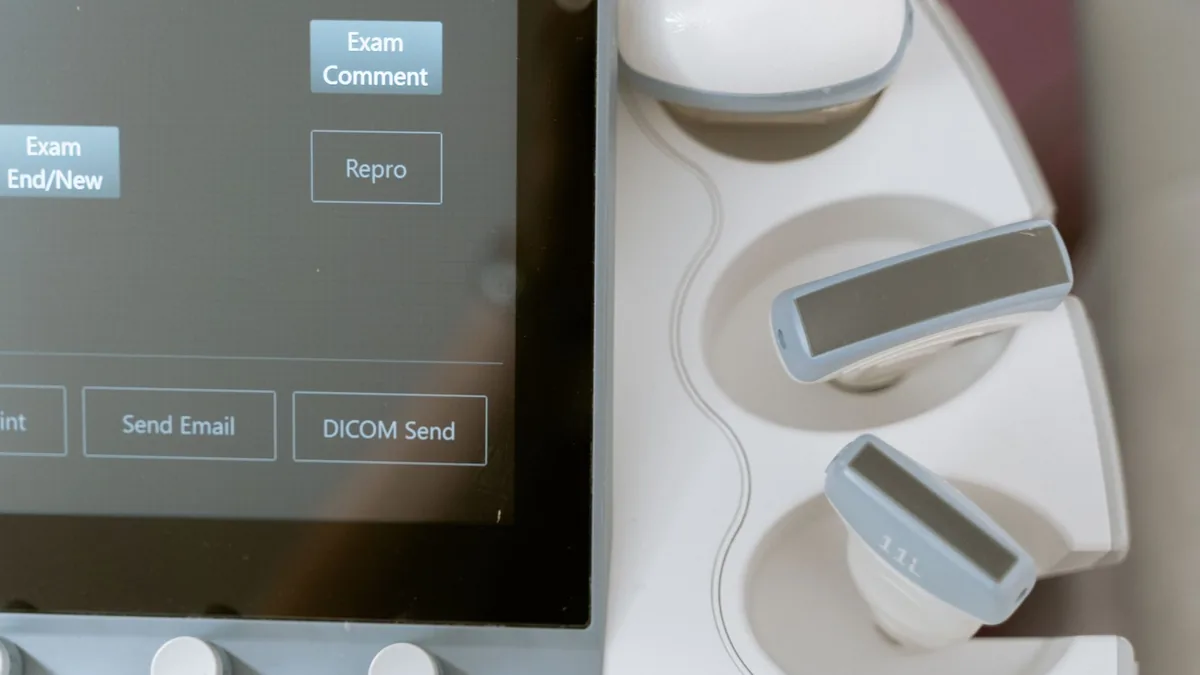 Close-up image of ultrasound equipment showing the monitor and probe holders.